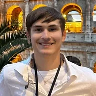 Benjamin Graham Richards smiling in front of the Colosseum in Rome